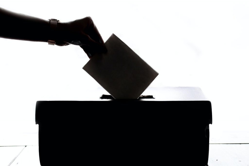 Wyborca umieszcza kartę do głosowania w urnie.